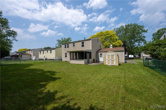 897 Fairmont Ave, North Tonawanda, NY 14120 - back of house with a sunroom, a storage shed, and a fenced backyard