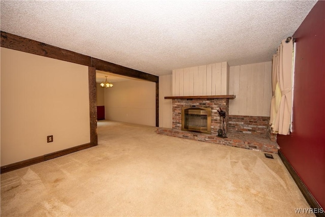 897 Fairmont Ave, North Tonawanda, NY 14120 - unfurnished living room with carpet flooring, a chandelier, a textured ceiling, and a fireplace