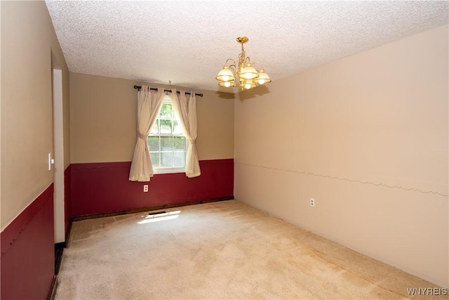 897 Fairmont Ave, North Tonawanda, NY 14120 - unfurnished room featuring a chandelier, carpet floors, and a textured ceiling