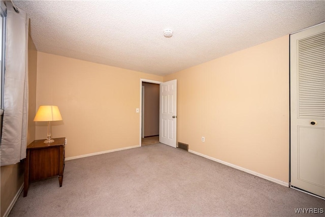 897 Fairmont Ave, North Tonawanda, NY 14120 - unfurnished bedroom with carpet, a textured ceiling, and a closet