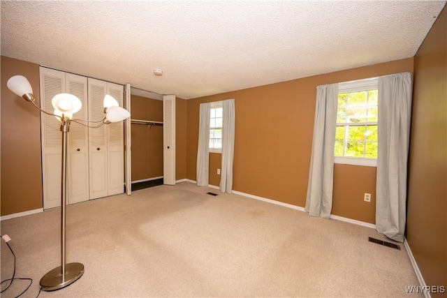 897 Fairmont Ave, North Tonawanda, NY 14120 - spare room featuring plenty of natural light, a textured ceiling, and light carpet