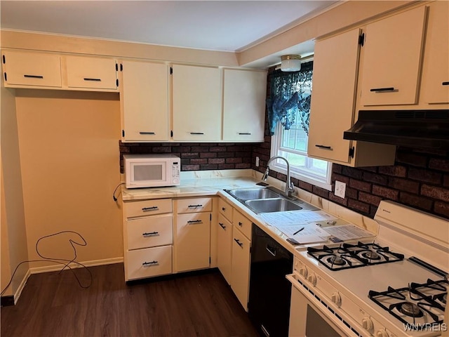 897 Fairmont Ave, North Tonawanda, NY 14120 - kitchen featuring white appliances, under cabinet range hood, light countertops, dark wood-type flooring, and tasteful backsplash