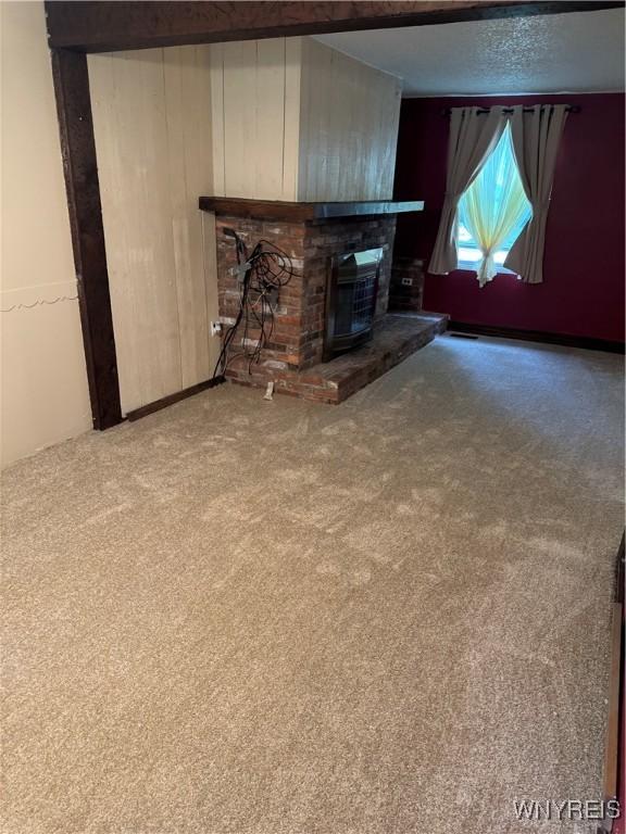 897 Fairmont Ave, North Tonawanda, NY 14120 - unfurnished living room with a fireplace, carpet floors, and wood walls
