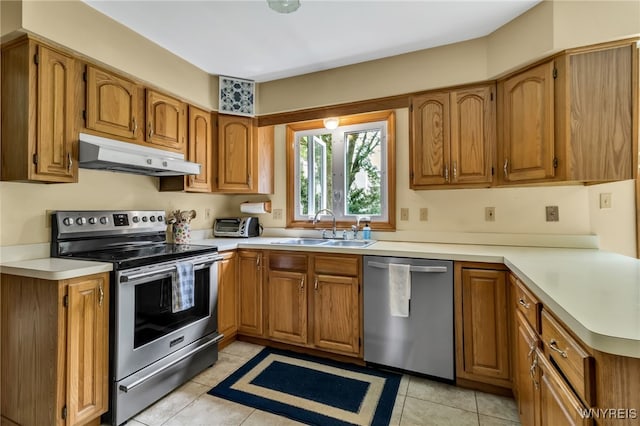 25 5th Ave, Amherst, NY 14221 - kitchen with stainless steel appliances, under cabinet range hood, a sink, and brown cabinets