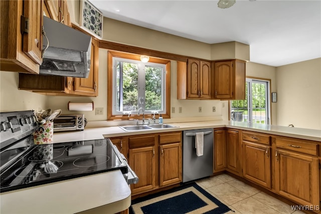 25 5th Ave, Amherst, NY 14221 - kitchen with stainless steel appliances, a sink, exhaust hood, brown cabinets, and light countertops