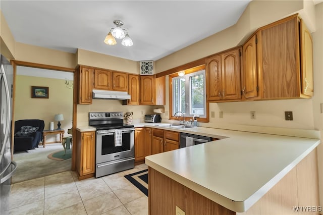 25 5th Ave, Amherst, NY 14221 - kitchen with stainless steel appliances, under cabinet range hood, a sink, light countertops, and a peninsula