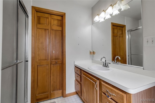 25 5th Ave, Amherst, NY 14221 - bathroom featuring vanity, a closet, tile patterned floors, an enclosed shower, and baseboards