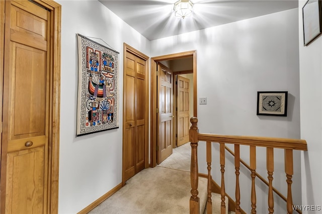 25 5th Ave, Amherst, NY 14221 - corridor featuring an upstairs landing, light carpet, and baseboards