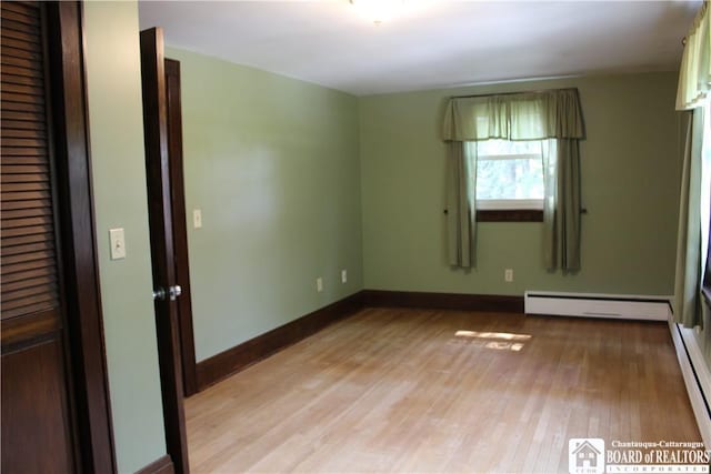 3582 Rte 20, Sheridan, NY 14063 - unfurnished room with baseboard heating, light wood-type flooring, and baseboards