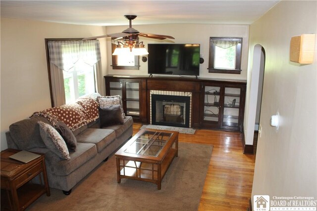 3582 Rte 20, Sheridan, NY 14063 - living area featuring plenty of natural light, wood finished floors, arched walkways, and ceiling fan