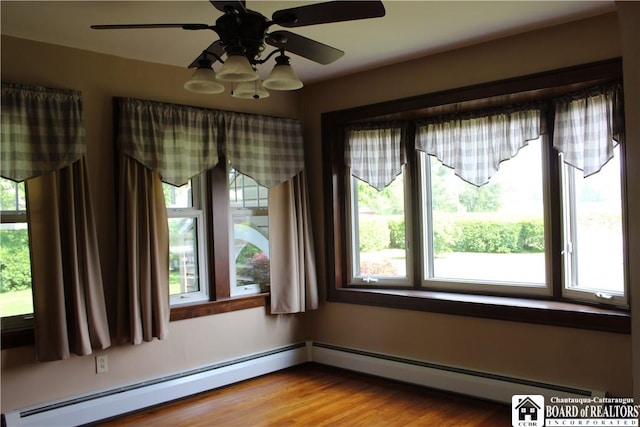 3582 Rte 20, Sheridan, NY 14063 - empty room with ceiling fan, a baseboard heating unit, and wood finished floors