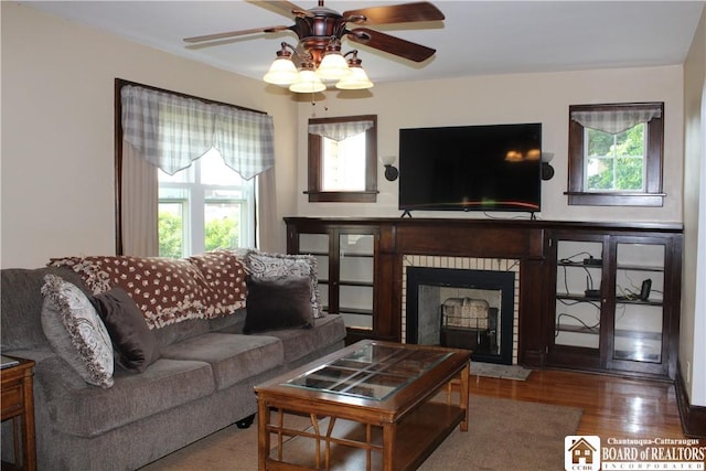 3582 Rte 20, Sheridan, NY 14063 - living area with ceiling fan, a brick fireplace, and wood finished floors