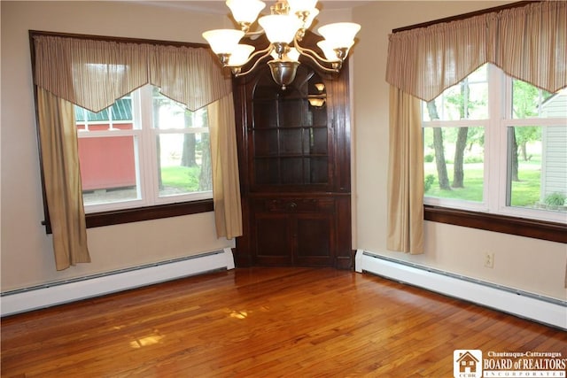 3582 Rte 20, Sheridan, NY 14063 - unfurnished dining area featuring a baseboard heating unit, a chandelier, and healthy amount of natural light