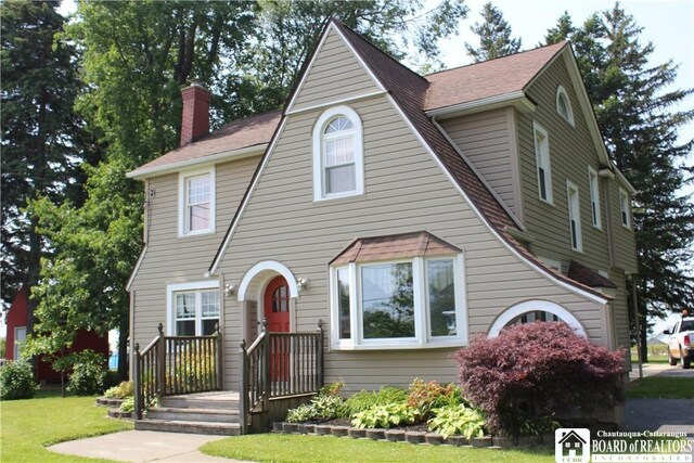 3582 Rte 20, Sheridan, NY 14063 - tudor home with a chimney, a front lawn, and roof with shingles