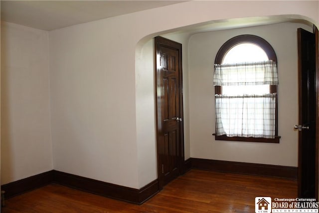 3582 Rte 20, Sheridan, NY 14063 - hallway with arched walkways, dark wood-style flooring, and baseboards