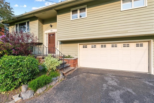 112 Elmcrest Cir, Salina, NY 13090 - view of front of house with an attached garage and asphalt driveway