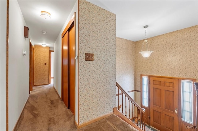 112 Elmcrest Cir, Salina, NY 13090 - entrance foyer with light colored carpet, wallpapered walls, baseboards, and stairs