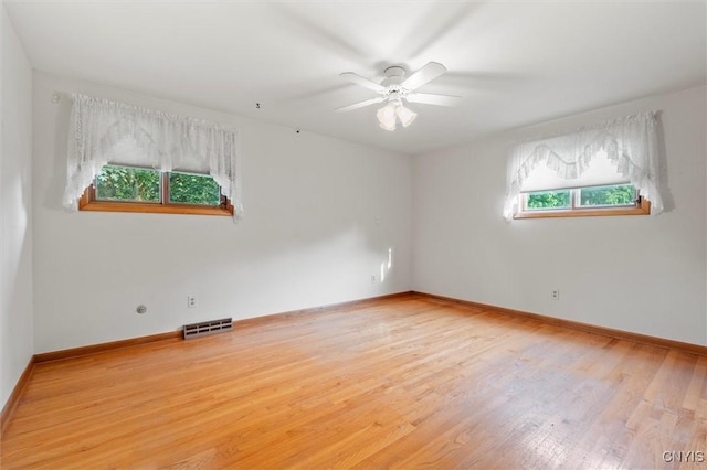 112 Elmcrest Cir, Salina, NY 13090 - unfurnished room with plenty of natural light, wood finished floors, and baseboards