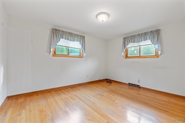 112 Elmcrest Cir, Salina, NY 13090 - empty room with plenty of natural light, wood finished floors, and baseboards