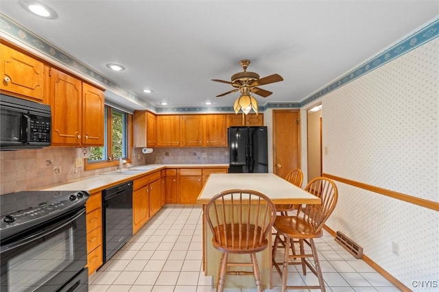 112 Elmcrest Cir, Salina, NY 13090 - kitchen featuring black appliances, light countertops, a ceiling fan, light tile patterned flooring, and a kitchen island