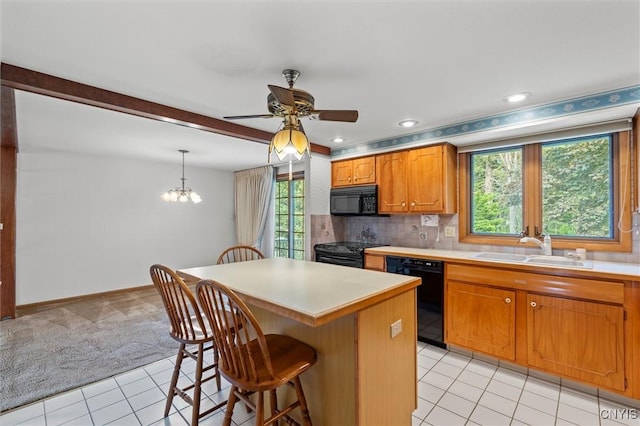112 Elmcrest Cir, Salina, NY 13090 - kitchen with black appliances, a sink, light tile patterned floors, a ceiling fan, and a kitchen breakfast bar