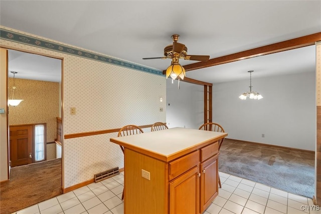 112 Elmcrest Cir, Salina, NY 13090 - kitchen featuring light carpet, a ceiling fan, a kitchen island, light tile patterned floors, and beam ceiling