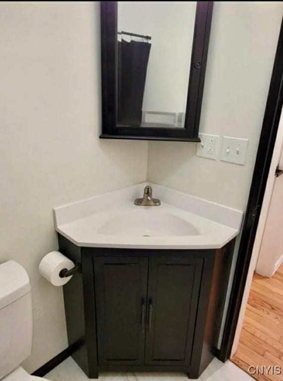 706 Dawes Ave, Utica, NY 13502 - bathroom featuring vanity, toilet, and wood finished floors