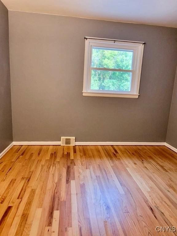 706 Dawes Ave, Utica, NY 13502 - empty room featuring wood finished floors and baseboards