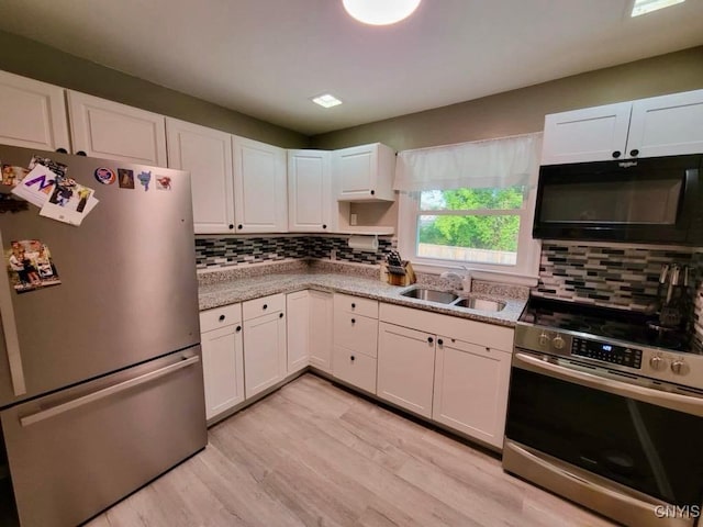 706 Dawes Ave, Utica, NY 13502 - kitchen featuring appliances with stainless steel finishes, a sink, tasteful backsplash, and white cabinets