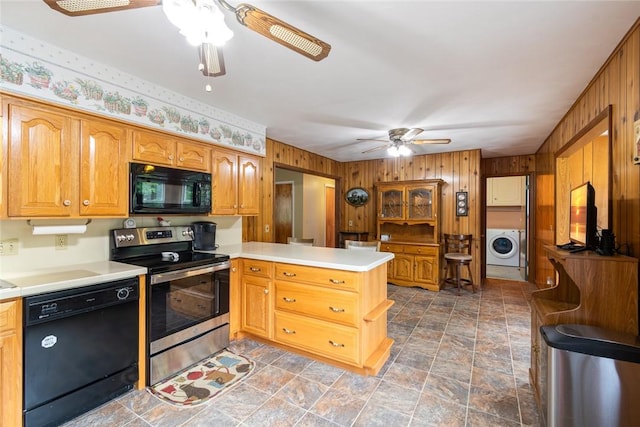 141 W Pearl St, Arcadia, NY 14513 - kitchen featuring black appliances, a ceiling fan, washer / dryer, a peninsula, and wood walls