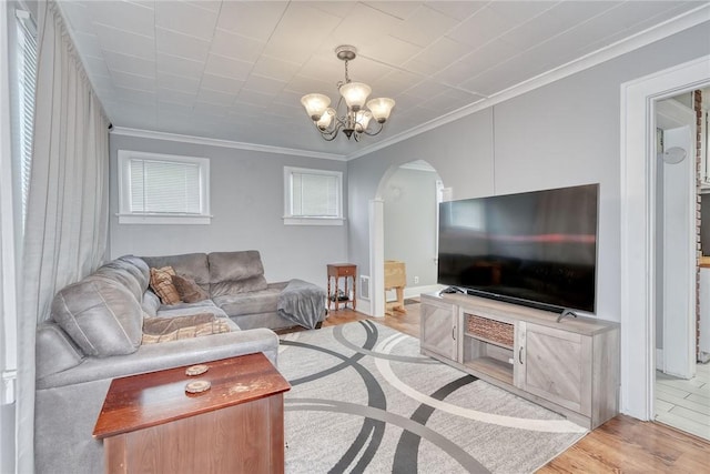 42 Worcester Rd, Greece, NY 14616 - living area featuring arched walkways, a chandelier, ornamental molding, and wood finished floors