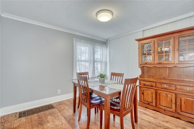 42 Worcester Rd, Greece, NY 14616 - dining area with ornamental molding, light wood-style floors, and baseboards