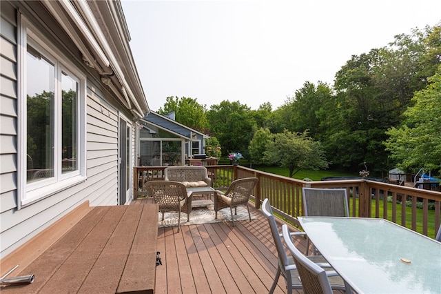 281 Burley Rd, Rochester, NY 14612 - deck with outdoor dining space, a lawn, outdoor lounge area, and view of wooded area