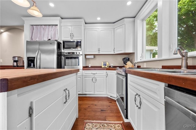 55 E 5th St, Oswego-City, NY 13126 - kitchen with stainless steel appliances, recessed lighting, white cabinetry, dark wood-type flooring, and butcher block countertops