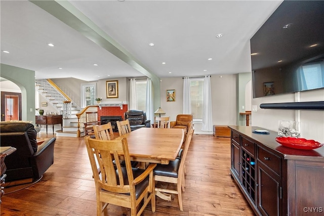 55 E 5th St, Oswego-City, NY 13126 - dining space with stairs, arched walkways, light wood-style flooring, and recessed lighting