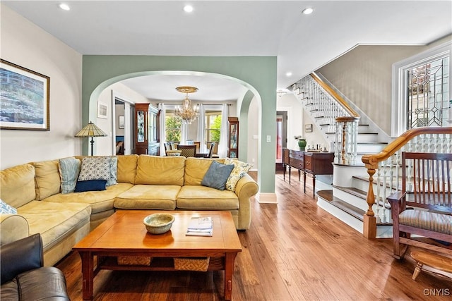 55 E 5th St, Oswego-City, NY 13126 - living room with arched walkways, a chandelier, wood-type flooring, stairs, and recessed lighting