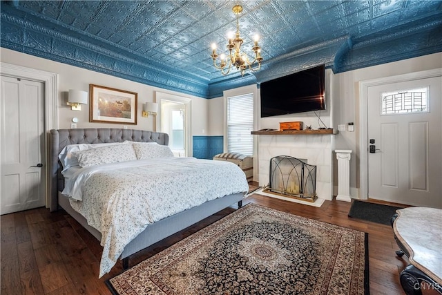 55 E 5th St, Oswego-City, NY 13126 - bedroom with an ornate ceiling, wood-type flooring, a chandelier, and a fireplace