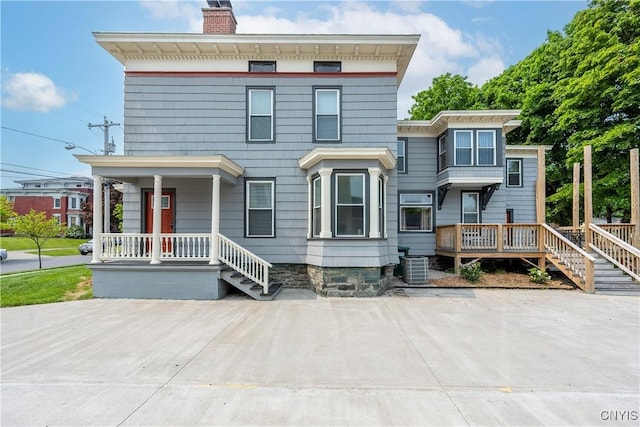 55 E 5th St, Oswego-City, NY 13126 - italianate home with a porch, a chimney, and central AC unit