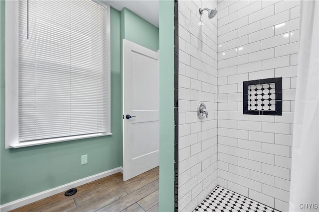 55 E 5th St, Oswego-City, NY 13126 - bathroom featuring a stall shower, wood finished floors, and baseboards