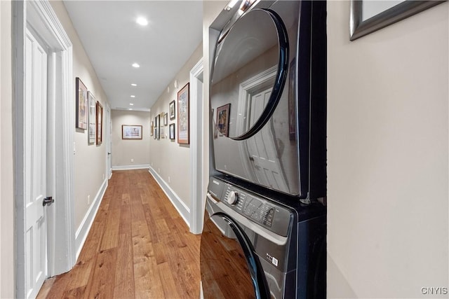 55 E 5th St, Oswego-City, NY 13126 - corridor featuring estacked washer and dryer, light wood-style flooring, recessed lighting, and baseboards