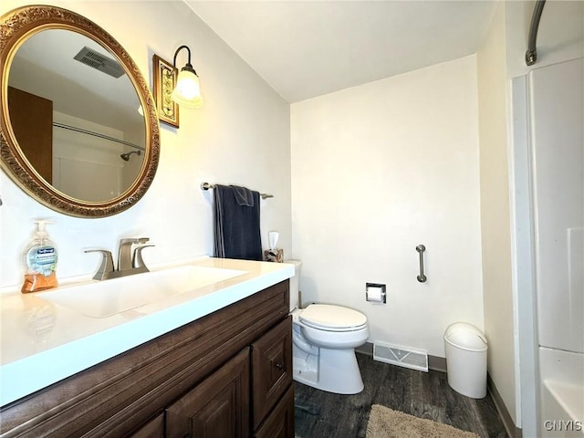 4936 Look Kinney Cir, Clay, NY 13088 - bathroom featuring toilet, wood finished floors, vanity, baseboards, and a shower