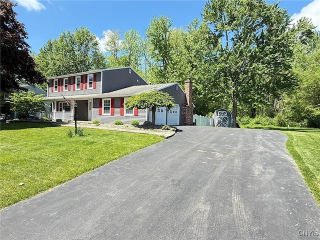 4936 Look Kinney Cir, Clay, NY 13088 - colonial-style house featuring a garage, driveway, a front lawn, a shed, and a porch