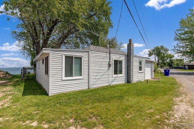 17 Porter Center Rd Unit N, Porter, NY 14174 - view of side of home with a garage, a chimney, a lawn, and driveway