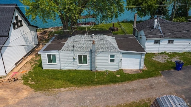 17 Porter Center Rd Unit N, Porter, NY 14174 - view of home's exterior featuring a garage, a shingled roof, and a yard