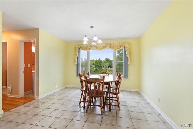 2220 W Genesee Tpke, Camillus, NY 13031 - dining room with a chandelier, light tile patterned flooring, and baseboards