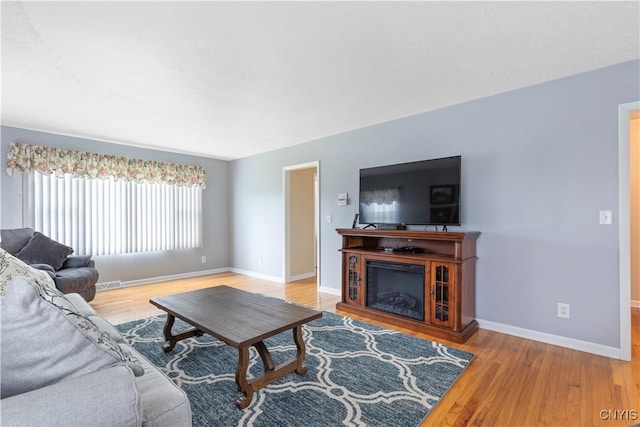 2220 W Genesee Tpke, Camillus, NY 13031 - living room with wood finished floors, baseboards, and a glass covered fireplace