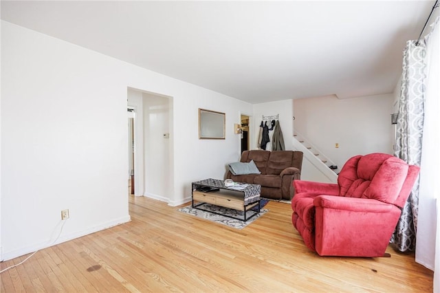 12 Queensboro Rd, Irondequoit, NY 14609 - living area featuring stairway, light wood-style floors, and baseboards