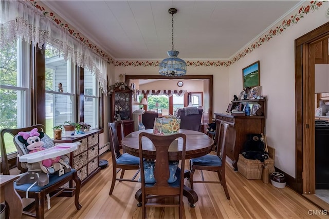 7632 E State St, Lowville, NY 13367 - dining room featuring light wood-type flooring, baseboard heating, and ornamental molding