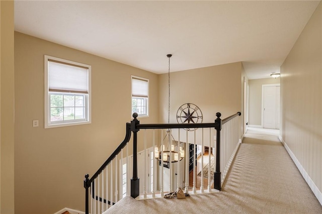 74 Broadmoor Trl, Perinton, NY 14450 - hallway with an upstairs landing, baseboards, and carpet flooring