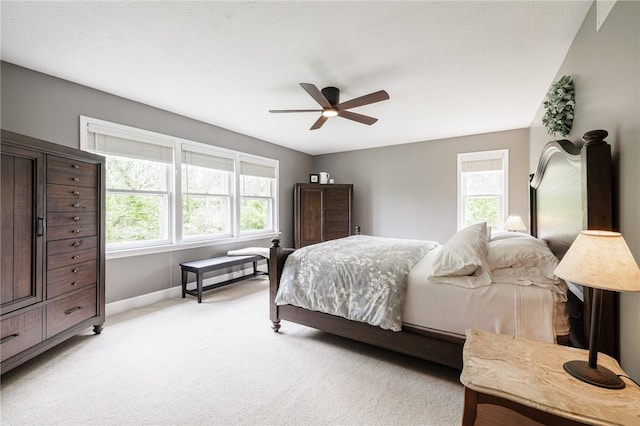 74 Broadmoor Trl, Perinton, NY 14450 - bedroom with multiple windows, light colored carpet, baseboards, and a ceiling fan